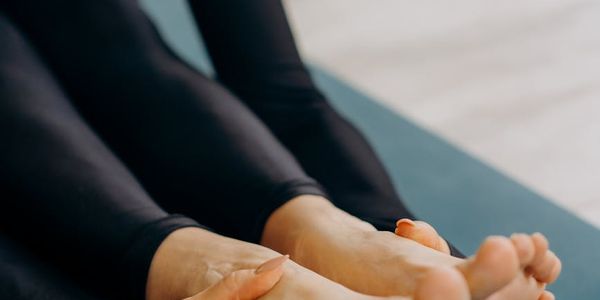 Close-up of feet on a yoga mat, showing balance.