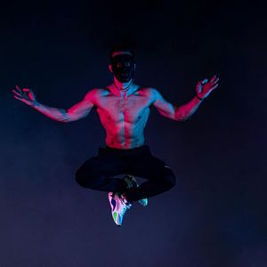 Dynamic pose captured in mid-motion against a simple background.