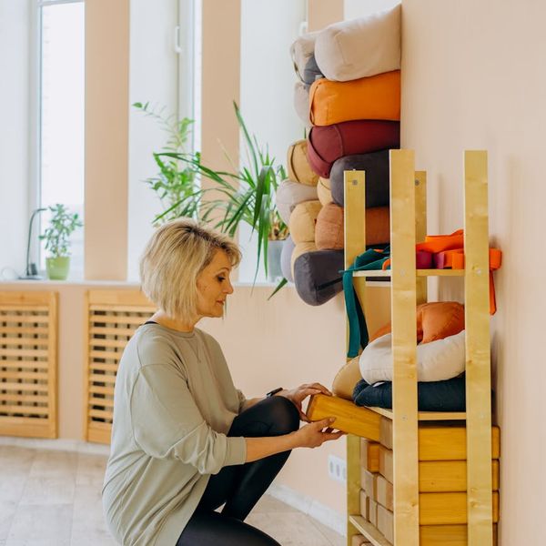 Person stretching calmly in a bright, spacious studio.